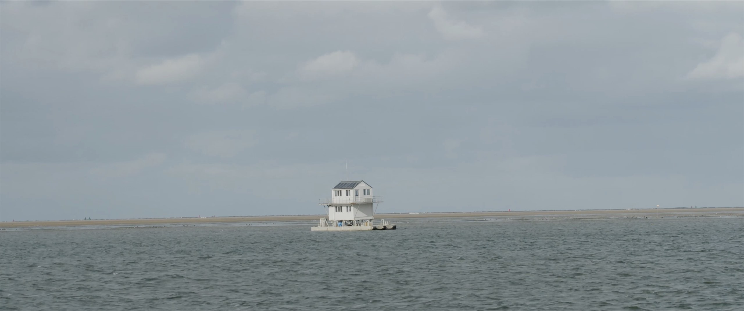 Image of a house on poles in the sea .jpg